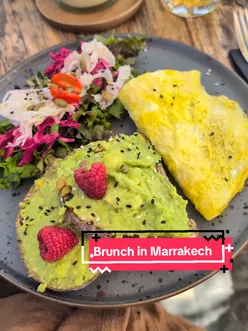 Brunch enthusiasts enjoying vibrant dishes at Mandala Society, a sustainable vegetarian café in Marrakech's medina.