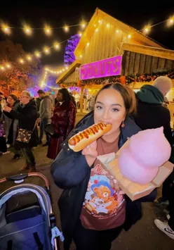 Three adults sharing a food haul from Tulleys Farm during Shocktober at the pumpkin patch.