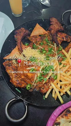 “Colorful tawa platter with lamb chops, seekh kebabs, and chicken served at Saleem's Tawa & Grill in Manchester.”