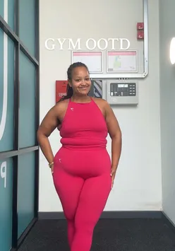 Gymshark's Build Pink seamless activewear on a confident plus-size gym girl, showcasing style and fitness.