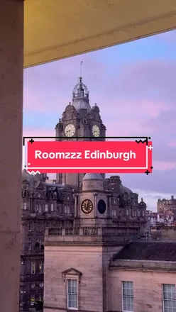Couple enjoying a relaxing weekend at Roomzzz Aparthotels, Edinburgh, with a cozy kitchen and city views.