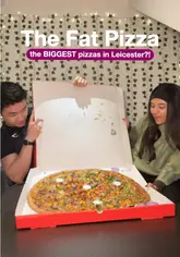 A promotional shot featuring two creators holding open a large pizza box to reveal a 24-inch pizza, designed to highlight the scale of the food. The image uses a casual, influencer-style aesthetic with text overlays to communicate the venue name and the 'biggest pizza' selling point.