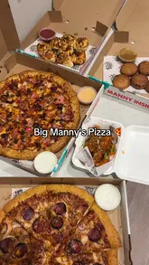 A food review video showcasing a delivery order from Big Manny's Pizza, featuring various pizzas, chicken tenders, 'lil twists', and cookies. The creator provides a voiceover review of the items.