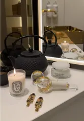 A short, aesthetic video featuring a woman enjoying a self-care routine in a luxury hotel room. The video highlights the room's amenities, including the bathroom and sleeping area, while the creator applies a face mask and drinks a green juice, promoting a relaxing, 'girl therapy' lifestyle vibe.