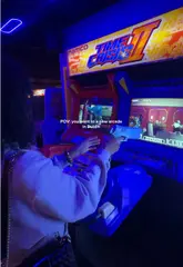 A POV-style video showcasing a visit to an arcade bar in Dublin, featuring various retro arcade games, a karaoke room, and casual dining options like burgers and nachos.