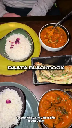 Diners enjoying a meal at Daata Restaurant in Dublin, showcasing delicious dishes and a vibrant atmosphere.