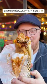 A creator visits a London restaurant, Shawarma Hut, highlighting its affordability and fresh food preparation. The video features the creator trying the food, showing the kitchen process, and interviewing the owner about their community-focused mission.