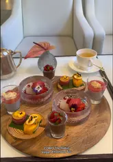 A visually appealing, polished montage showcasing the vegan afternoon tea experience at COMO The Halkin in London. The video highlights the aesthetic presentation of both savoury and sweet dishes, including close-ups of the food and the tea service, set to a calm, relaxing soundtrack.