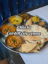 A short, personal review of Chai Street in Cardiff, focusing on their vegan thali offering. The video features close-up shots of the food, the drink, and the restaurant exterior, accompanied by a voiceover explaining the creator's experience.