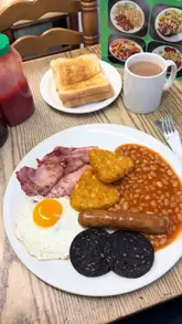 Breakfast spread at The Canteen Cafe, Cambridge Heath: eggs, bacon, and coffee in a cozy diner setting.