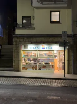 Man savoring Asian-style sandos at Toast Tea in Edinburgh, hoping to discover a hidden gem for food lovers.