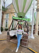 A short video showcasing the Feast on Cloud 9 afternoon tea experience located within the Syon Park conservatory. The video features the unique dining setup where tables are housed inside decorative hot air balloon structures, followed by shots of the afternoon tea spread, including sandwiches, scones, and desserts.