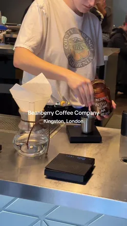 Runners enjoying coffee at Beanberry in Kingston, London, with a vibrant selection of pastries and cozy seating.