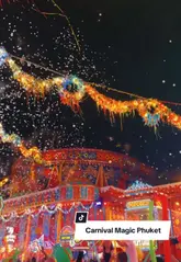 A fast-paced, visually striking montage showcasing the 'Carnival Magic' theme park in Phuket, Thailand. The video highlights the vibrant light displays, theatrical performers, carnival games, and the overall festive atmosphere of the attraction at night.
