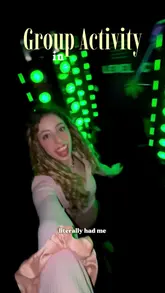 A fast-paced, energetic video showcasing an interactive group activity venue in London called Boom Lab. The creator takes the viewer through various challenge rooms, including laser mazes and paint-based games, highlighting the fun, competitive atmosphere suitable for groups of friends.