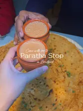 Enjoying a variety of flavorful desi dishes at Paratha Stop, including channa paratha, samosa chaat, tea, and a mojito.