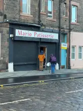 A creator visits a small, seemingly hidden Polish bakery in Edinburgh called Mario Patisserie. He documents his experience trying to visit, the shop's appearance, and performs a taste test of a doughnut and an apple pastry at home, providing a positive review of the quality and value.