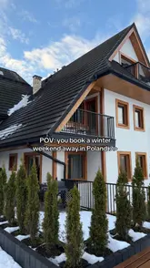 Tourists exploring scenic Zakopane, Poland, surrounded by stunning mountain views and charming local architecture.