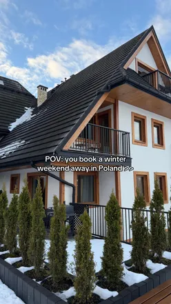 Tourists exploring scenic Zakopane, Poland, surrounded by stunning mountain views and charming local architecture.