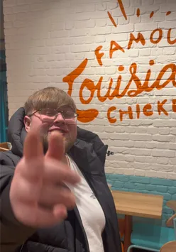 Excited content creator sharing updates at Popeyes, highlighting delicious food and engaging with followers.