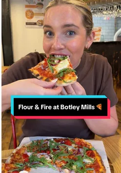 Visitors enjoying thin crust pizzas and garlic bread at Flour & Fire, a pizzeria in Botley, Southampton.