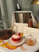 Hotel room welcome spread in Paris with birthday treats like snacks and drinks, set up for a romantic couples' getaway.