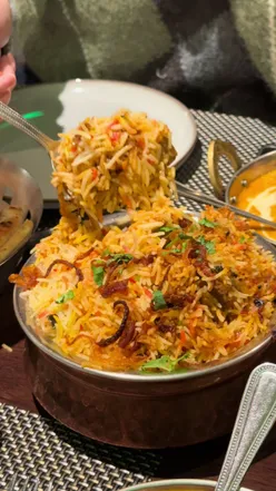 Assortment of vibrant Indian curries, fluffy basmati rice, and freshly baked naan bread at Ranmoor Bawarchi in Sheffield.
