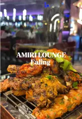 A couple visits Amiri Lounge in Ealing, showcasing a variety of dishes including a sizzling mixed grill, shrimp, biryani, and a milk cake dessert. The video features the creators trying the food and commenting on the flavors, highlighting the restaurant's Pan-Asian and Indian menu offerings.