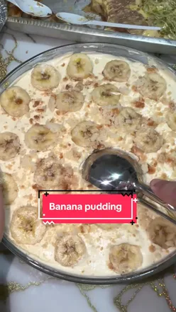 Delicious homemade banana pudding served in a glass bowl, topped with whipped cream and banana slices.