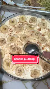 Delicious homemade banana pudding served in a glass bowl, topped with whipped cream and banana slices.