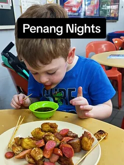 Family enjoying a food adventure in Penang, discovering local markets and dining experiences.