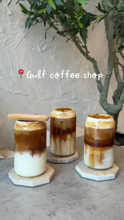 People enjoying iced coffee at Gulf Coffee Shop, a favorite spot in Manchester, with a cozy atmosphere.