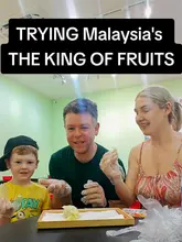 A family of three (parents and a young son) visit a street food stall in Malaysia to try durian, the 'King of Fruits'. The video documents their reactions to the smell, texture, and taste of the fruit, with the parents and child sharing their differing opinions on the experience.