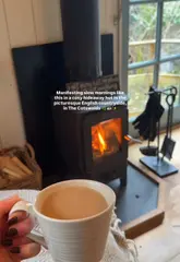 A montage showcasing a stay at a luxury hideaway hut in the Cotswolds, highlighting the cozy interior, breakfast, log burner, and bathtub.