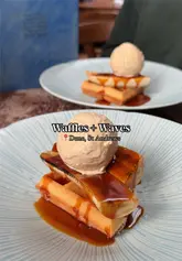 Delicious banana and ice cream waffles served with a vibrant cocktail at Waffles + Waves brunch club, St Andrews, Fife.