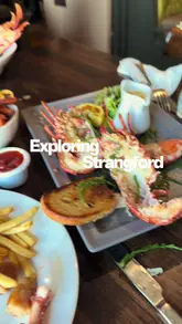 A short vlog-style video documenting a visit to The Lobster Pot in Strangford, Northern Ireland. The video features shots of the food, the exterior of the restaurant, and scenic drone footage of the surrounding harbour and ferry, highlighting a family day out.
