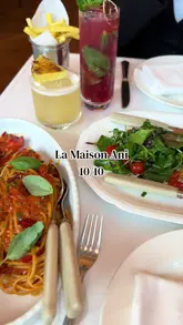 A review-style video showcasing a lunch visit to La Maison Ani in London, featuring shots of the restaurant's interior, bar, and various dishes including baby chicken, lobster linguine, and dessert.