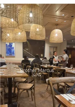 A vibrant spread of East Mediterranean mezze dishes including crispy calamari, grilled kofta, pita, and cocktails at Brother Marcus SoHo, London.