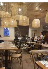 A vibrant spread of East Mediterranean mezze dishes including crispy calamari, grilled kofta, pita, and cocktails at Brother Marcus SoHo, London.