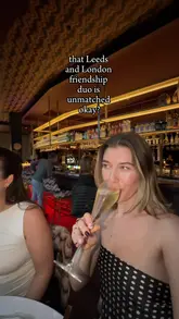 The video follows two friends enjoying a bottomless brunch at a modern restaurant. It features shots of them toasting with champagne, reviewing the menu, sharing various small plates and curries, and enjoying spicy mango margaritas. The video captures the lively atmosphere, including a DJ, and highlights the social aspect of the experience.