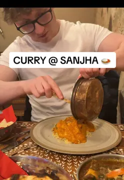 Vinnie Murphy eating an Indian curry dish at Sanjha restaurant in Southampton for a food review.