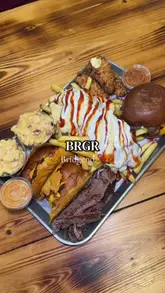 A review of a large sharing platter ('munch box') at a burger restaurant in Bridgend, featuring a variety of items like burgers, loaded fries, tenders, mac and cheese, and steak, followed by a selection of desserts.