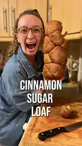 The creator demonstrates how to make a cinnamon sugar loaf at home, providing tips on dough consistency and baking techniques.