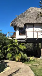 El Salvador boutique hotel with an infinity pool, lush tropical landscaping, and a stunning ocean view, perfect for a staycation.