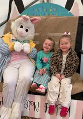 A montage of children enjoying an Easter-themed event at Green Barn Farm, featuring activities like an egg hunt, animal petting (chicks, lambs, guinea pigs), tractor rides, and meeting the Easter Bunny.