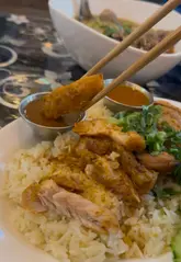 A food reviewer visits Rabbie's Noodle Hut in Wythenshawe, showcasing the casual dining experience, the chef preparing dishes, and reviewing several items including beef noodle soup, grilled chicken with rice, and pork and prawn pad thai.
