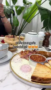 A hearty full English breakfast with eggs, bacon, sausage, beans, mushrooms, and toast at Cafe Lounge Kent.