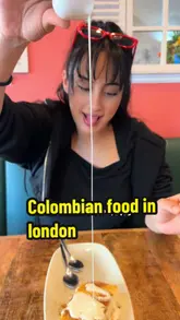 British Latina girl enjoying Colombian food at Donde Carlos restaurant in London for a food review.