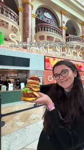 A creator visits the newly opened Shake Shack at the Trafford Centre, highlighting the venue's interior, the ordering process, and various menu items including burgers and chicken.