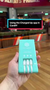 Person uses their phone and rents a portable power bank from a Charged Up machine in Cardiff after their battery ran low.